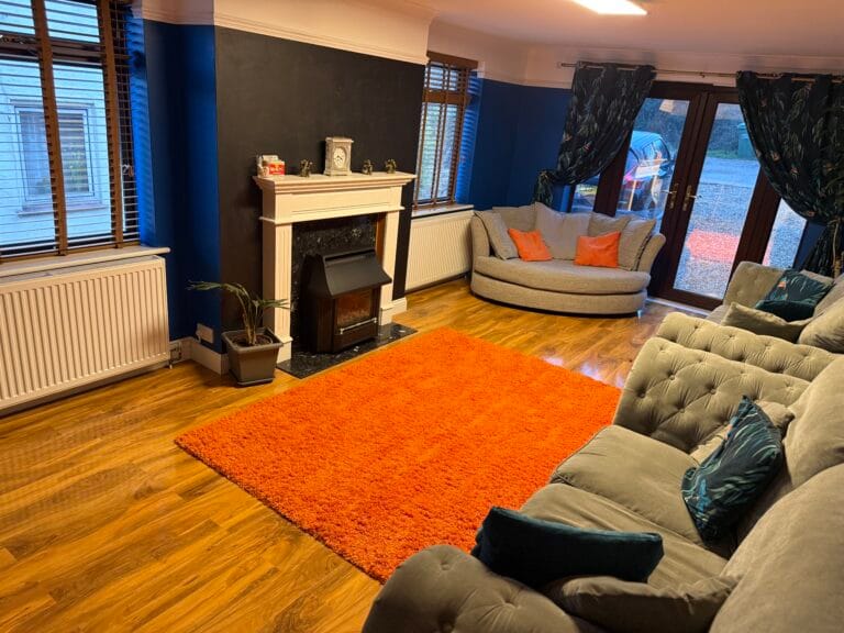 Supportive conversation between staff and teenager in a calm home setting